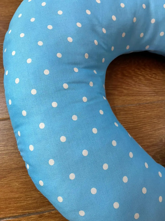 Blue polka dot neck pillow on wooden floor, Little Flower store product