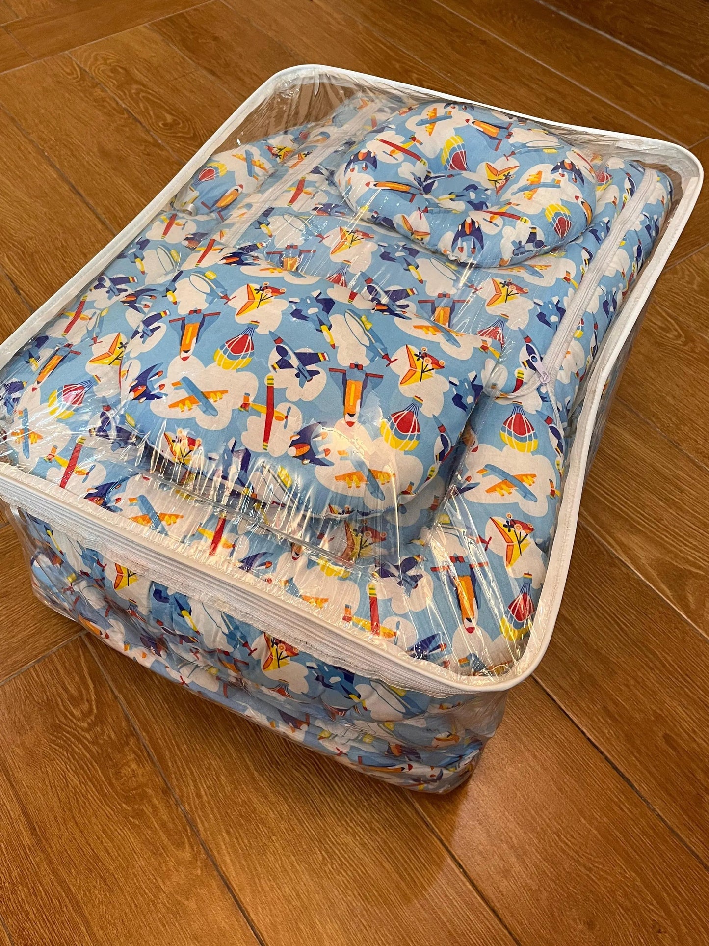 Clear plastic storage bag with colorful pattern on a wooden floor