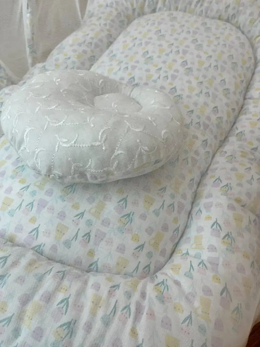 Soft baby lounger with floral pillow and pastel flower print, Little Flower brand