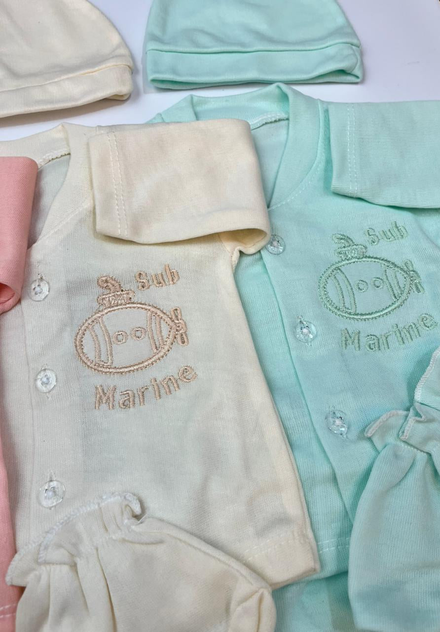 Baby clothing set with embroidered text on a white surface