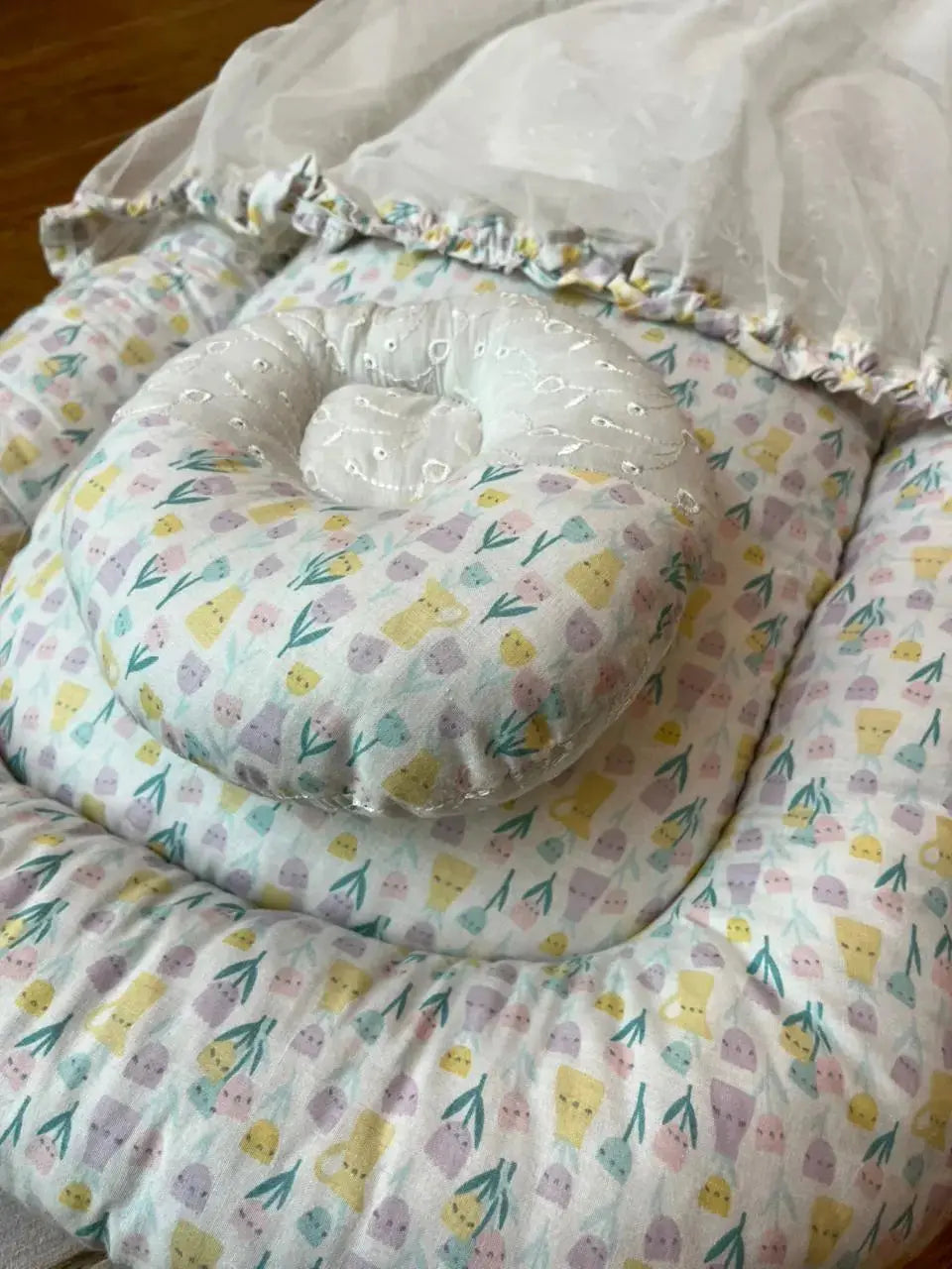 Pastel floral baby nest with matching pillow and white net covering, Little Flower